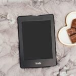 Image of a Kindle beside a plate of chocolate