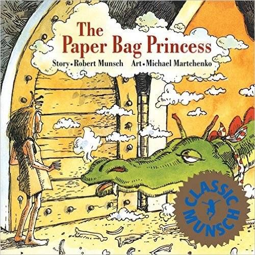 cover of The Paper Bag Princess; illustration of a blonde girl wearing a dress and a green dragon with its head coming in through the wooden door