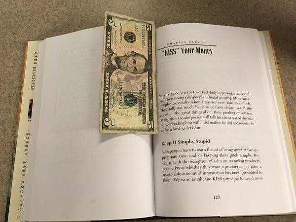 Money used as a bookmark in a Dave Ramsey book