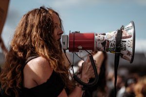 woman shouting protesting with megaphone