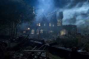 Promotional image of Hill House from the Netflix series. A large, run-down, spooky house, surrounded by fog.