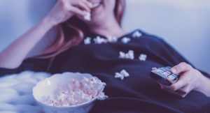 bookish tv shows woman eating popcorn television feature
