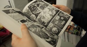 person holding an open manga