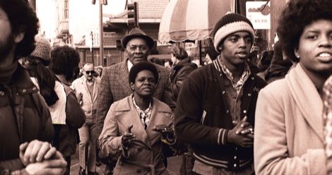 Members of Peoples Temple including Richard Parr, Wesley Johnson, Barbara Hickson, Ricky Johnson and Sandra Cobb attend an anti-eviction rally at the International Hotel, 848 Kearny Street in San Francisco, January 1977. Photo by Nancy Wong CC BY-SA 4.0