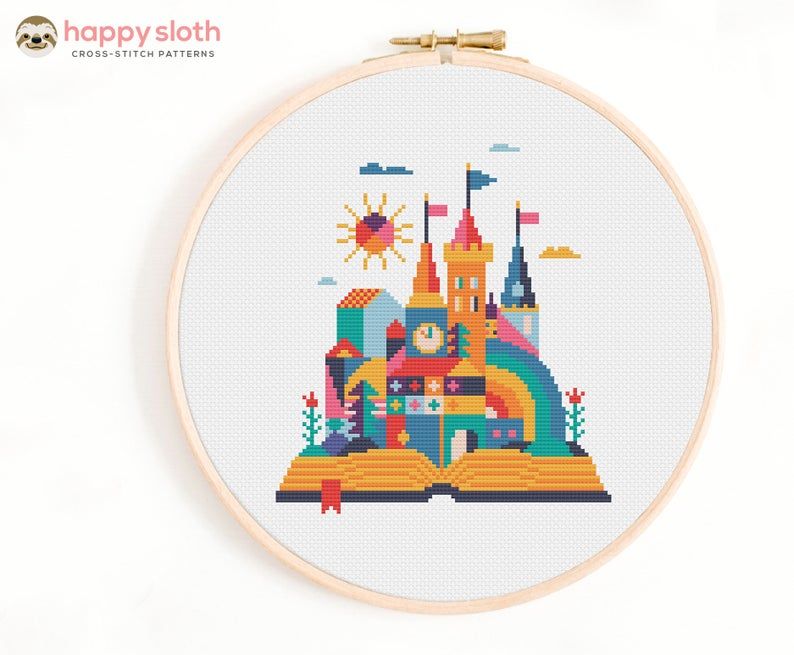 Cross stitch of a fairy tale castle emerging from an open book