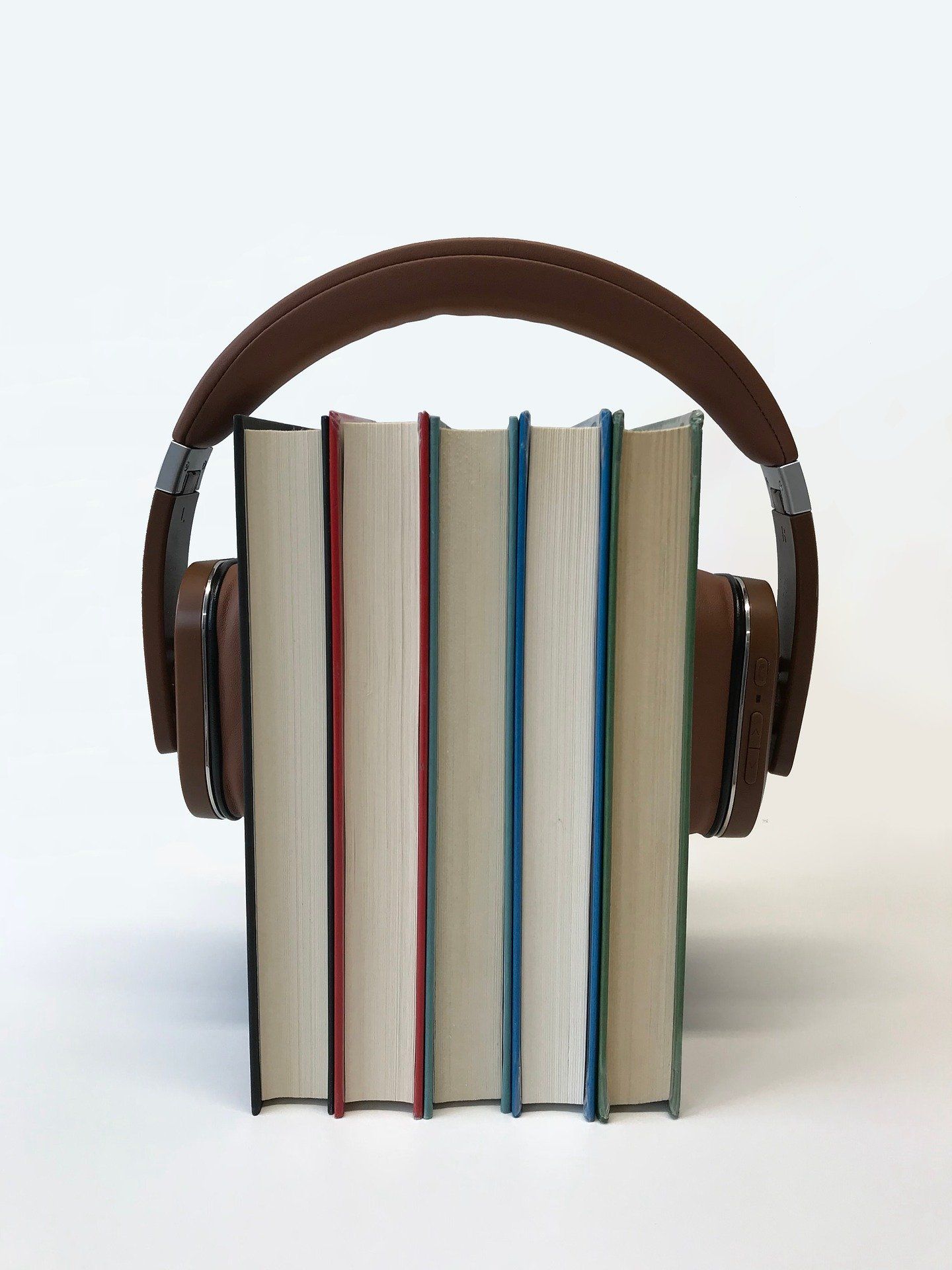 Books with a pair of headphones on them