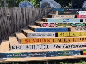 Stairway at the Calabash decorated with cover images and titles from featured books. Source: author.
