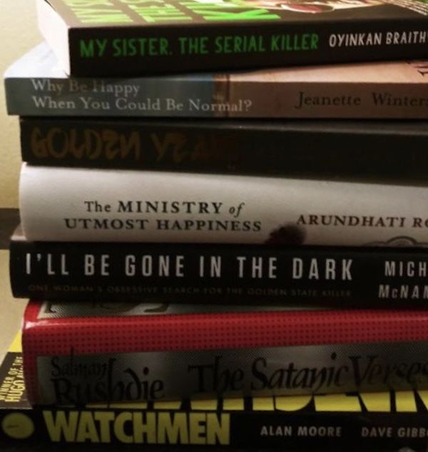 Books on a nightstand. Used with permission from the owner of the photo.