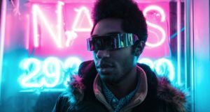 a photo of a Black man in front of a neon sign with futuristic glasses