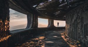 a photo of someone in an otherwordly landscape, like a long-abandoned skyscraper