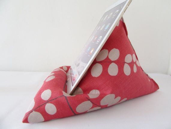 Pink and white book pillow. An iPad rests for support. Link: https://i.etsystatic.com/5660967/r/il/c1c0be/1921781214/il_1140xN.1921781214_6tiu.jpg