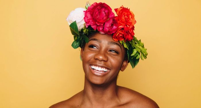 black joy black woman smiling with a flower crown