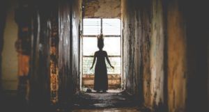 image of woman with hair standing up in an eerie hallway https://unsplash.com/photos/GSrgTVqS0dk
