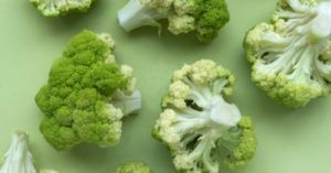 cauliflower heads against a green background