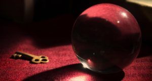 image of a crystal ball and a skeleton key on a red surface https://unsplash.com/photos/X0UrDOiHaS0