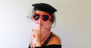 image of woman disguised by heart-shaped sunglasses, a black veil, and a bandana over her face https://unsplash.com/photos/3ohyK-zdPiM