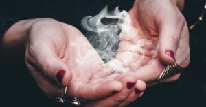 a photo of smoke in woman's hand
