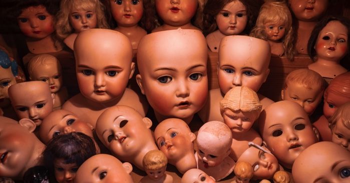 pile of doll heads