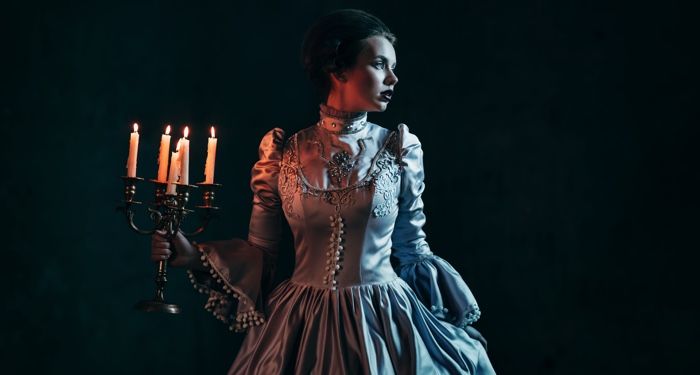 victorian woman holding candelabra