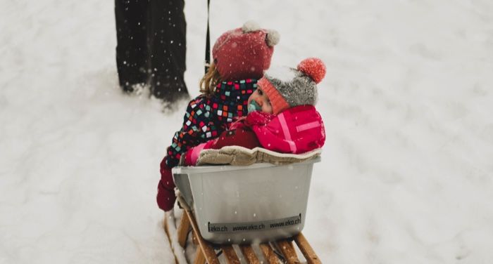 children in a sled in the snow
