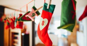 image of Christmas stockings handing on a line https://unsplash.com/photos/coXB9EFuWWg