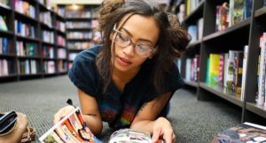 young woman reading a comic book