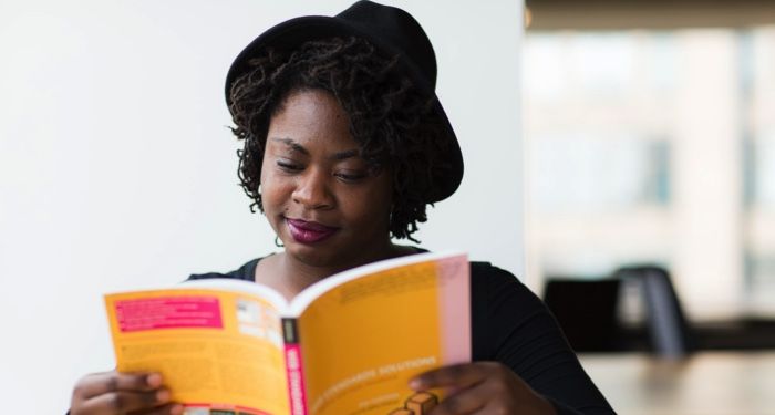 image of a woman reading a yellow book https://unsplash.com/photos/rBYYsIQcPBE