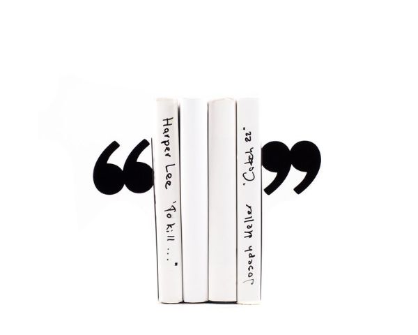 metal bookends that look like quotation marks on either side of a stack of books