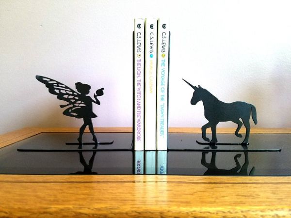 black metal silhouette of a fairy and unicorn on either side
