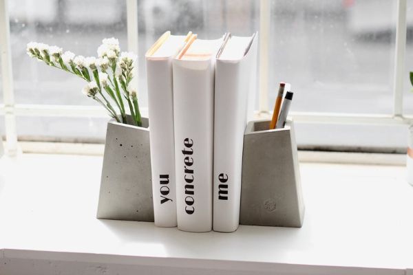 two blockish concrete vases used as bookends