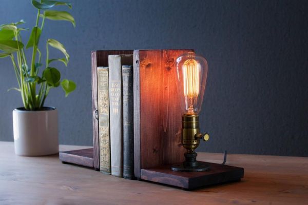 wood ends with an old fashioned light bulb as a lamp on one end