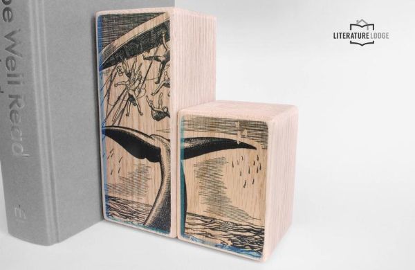 a small and tall wood block with a black and white whale image