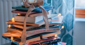 literary holidays books stacked as christmas tree with lights