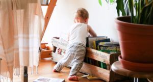 toddler looking through books for childrens feature