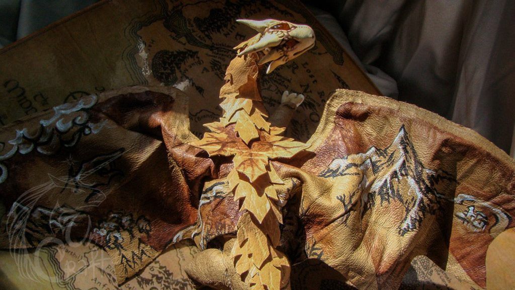 Posable leather dragon painted with elements of the map of Middle-earth