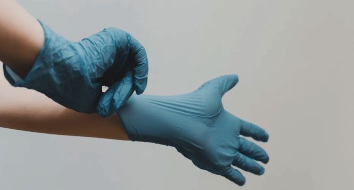 image of hands pulling on a pair of blue latex gloves https://unsplash.com/photos/cEzMOp5FtV4