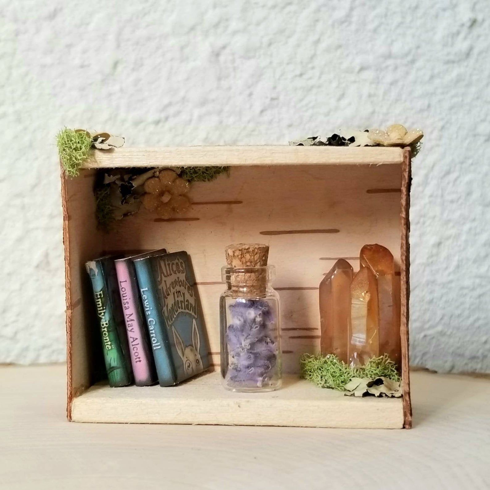 miniature bookshelf with crystals