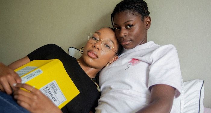 queer Black couple with book