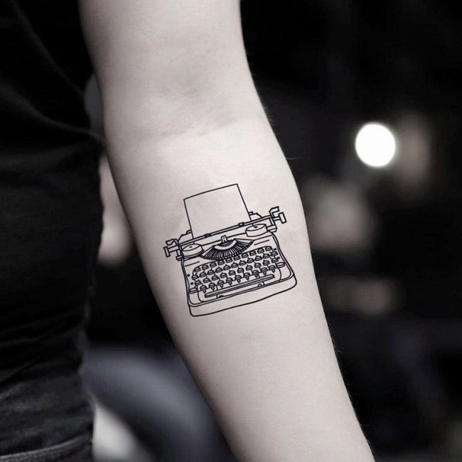 Image of a temporary tattoo of a vintage typewriter on a person’s forearm 