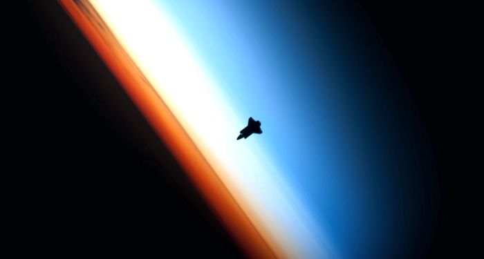 shuttle orbiting above earth's atmosphere https://unsplash.com/photos/7Cz6bWjdlDs