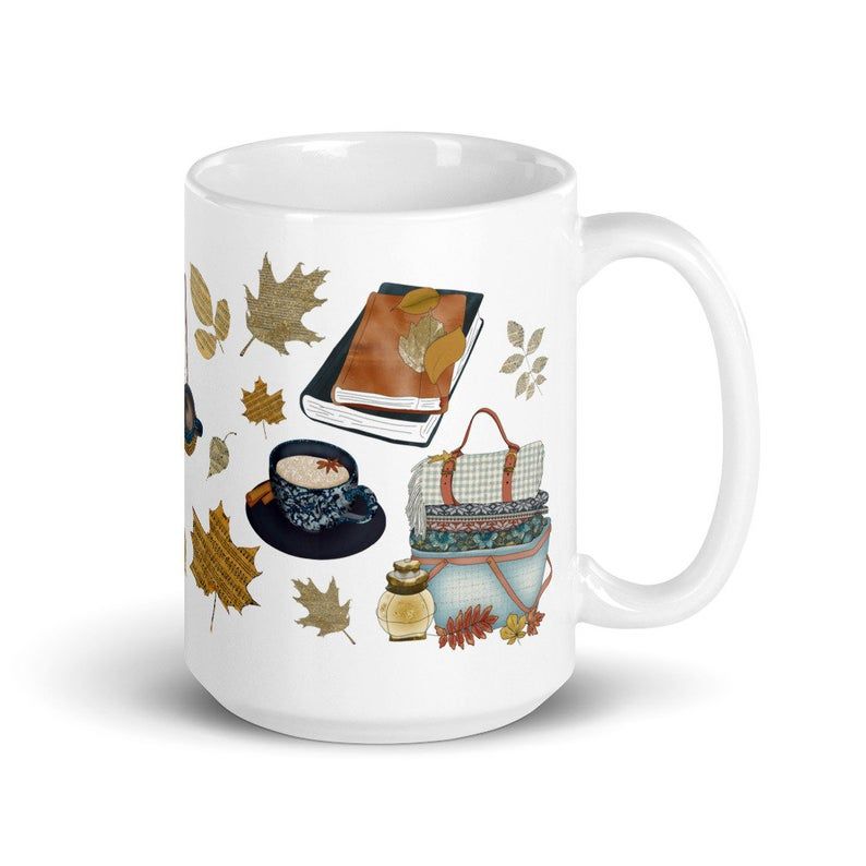 Image of white mug with cats, scarves, and books. 