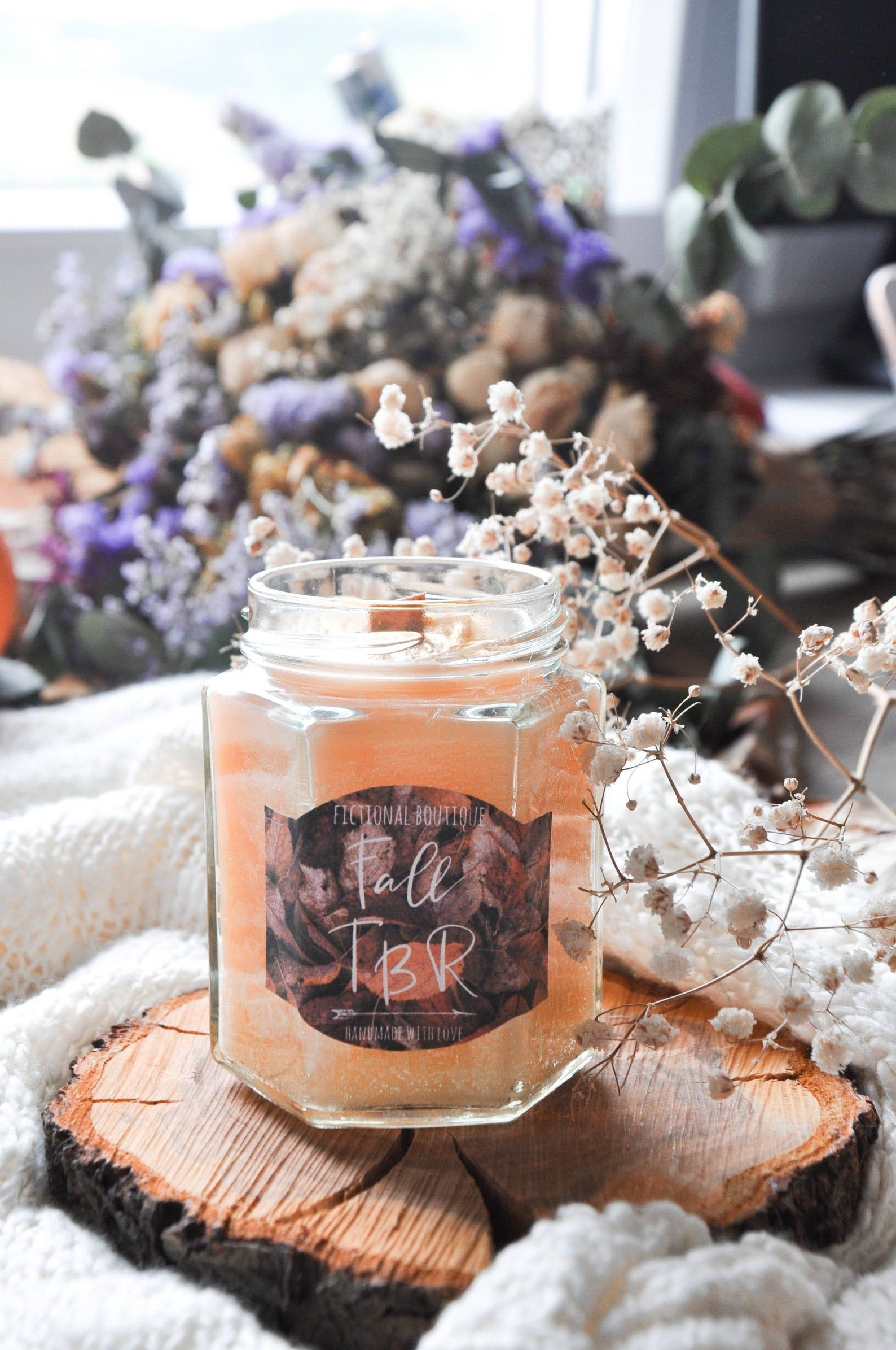 Image of orange sparkly candle named "Fall TBR."