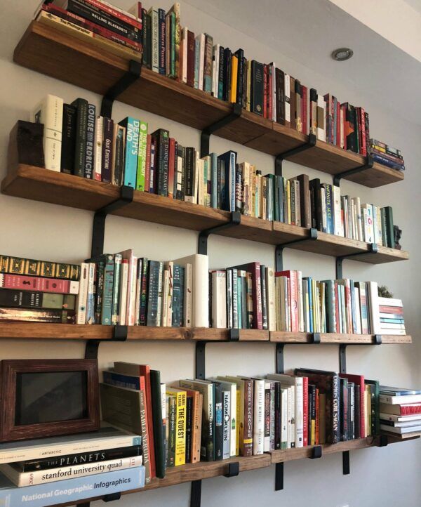 Long wooden wall shelves, filled with books