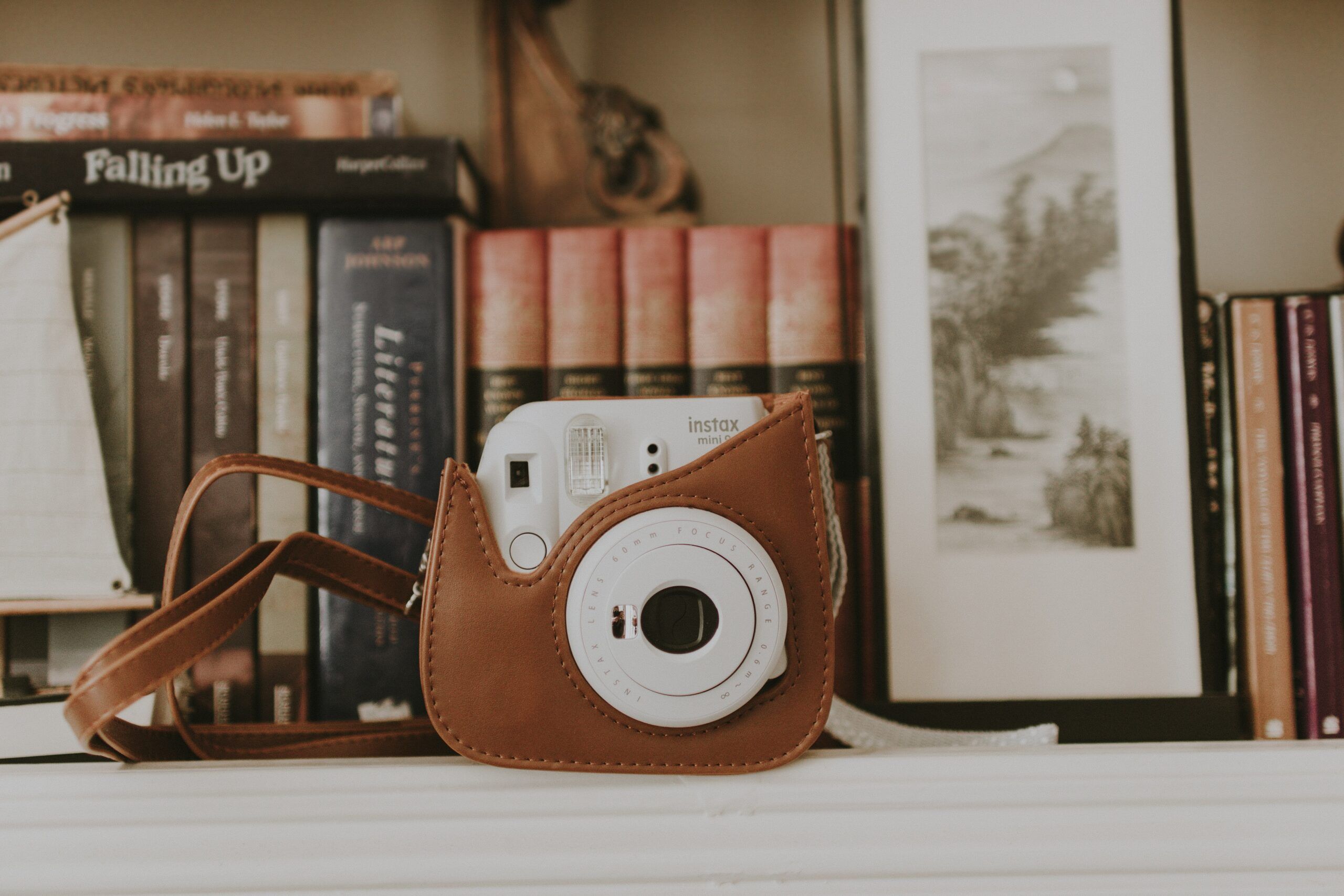 how to sell books on etsy photos: a polaroid-style camera with books lined up in the background