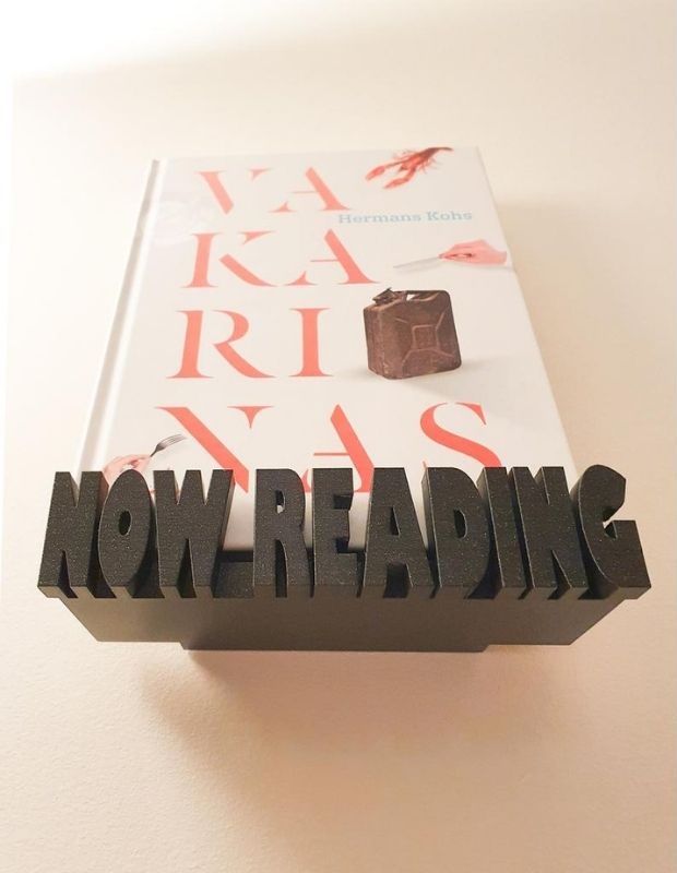 Wooden floating shelf with "Now Reading" lettering on front ledge