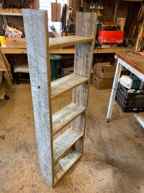 Simple, tall narrow bookcase made from reclaimed barn wood