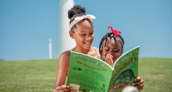 two Black girls reading together