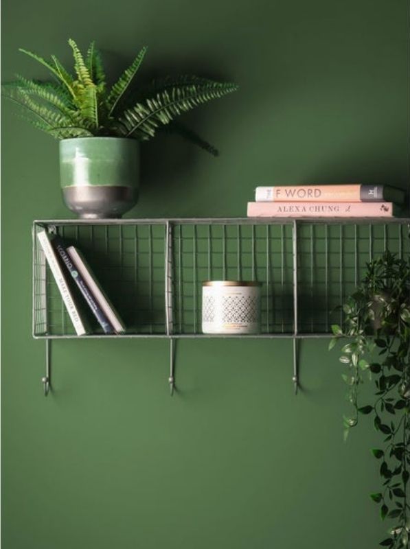 Horizontal wire rack with three compartments and four hooks along bottom