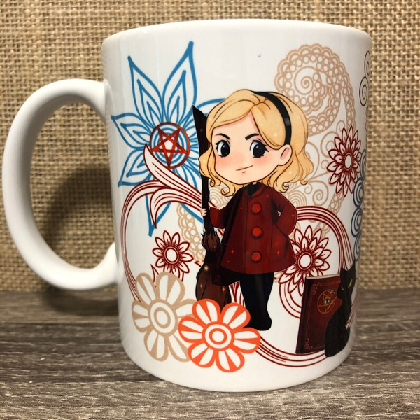 A paisley print coffee mug with a stylized version of Sabrina Spellman from Chilling Adventures of Sabrina.