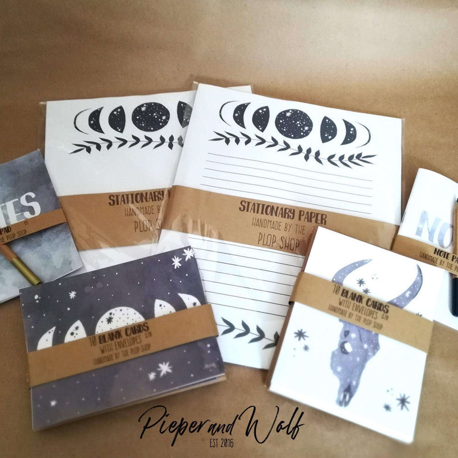 Cards and paper featuring moon phases and desert skulls.
